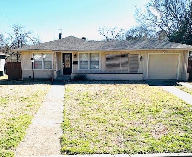 single story home featuring a garage, a front yard, and fence