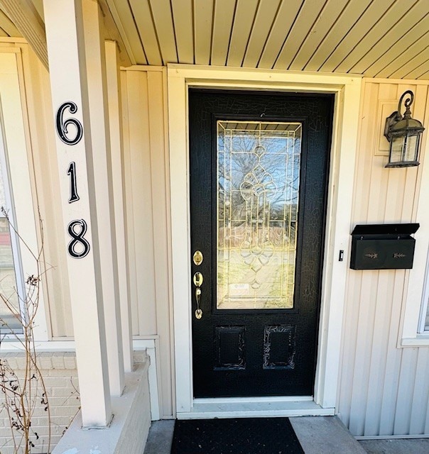 property entrance featuring board and batten siding