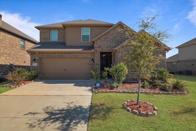 traditional-style home featuring a garage, a front lawn, concrete driveway, and brick siding