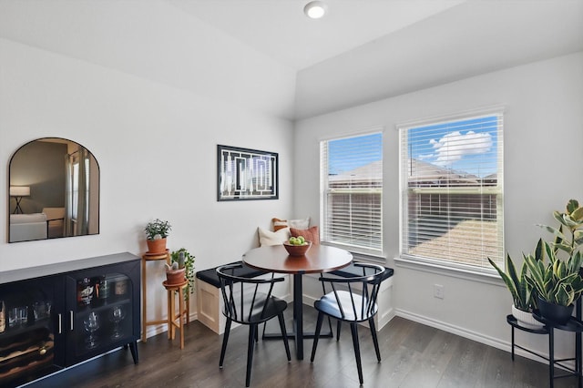 dining space with wood finished floors and baseboards