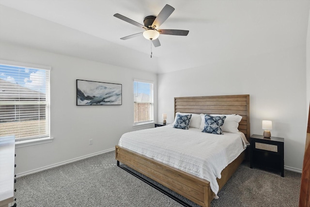 carpeted bedroom with ceiling fan, multiple windows, and baseboards