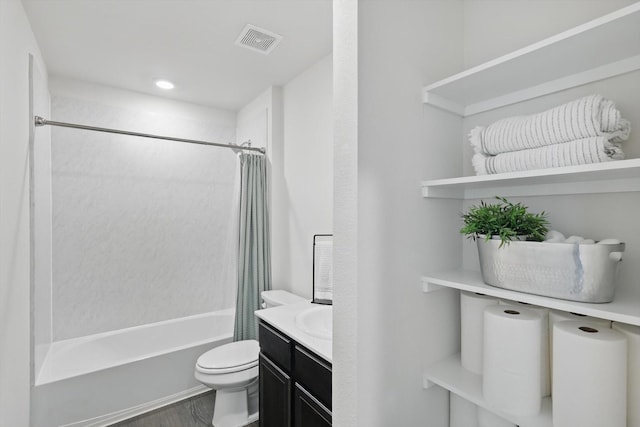 full bathroom featuring shower / tub combo, visible vents, toilet, wood finished floors, and vanity