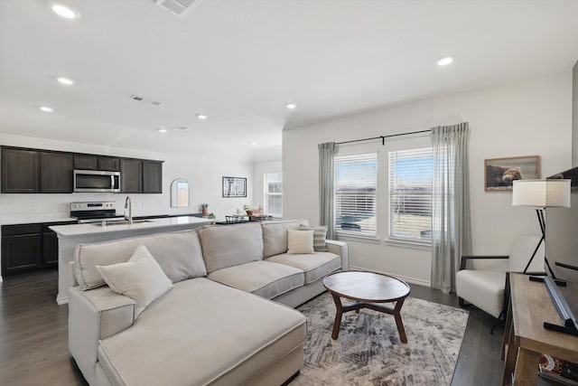 living room featuring dark wood-style flooring and recessed lighting