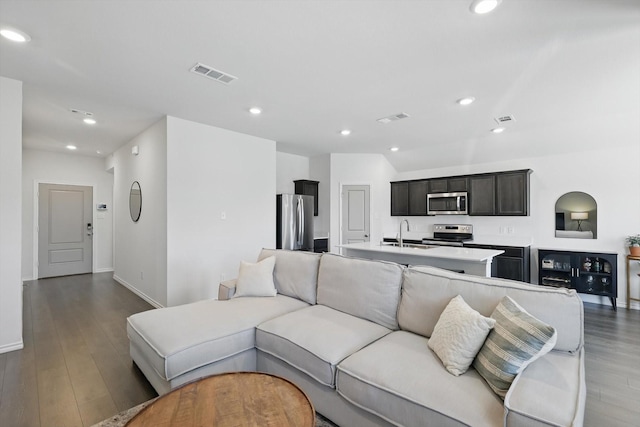 living area featuring visible vents, wood finished floors, and recessed lighting