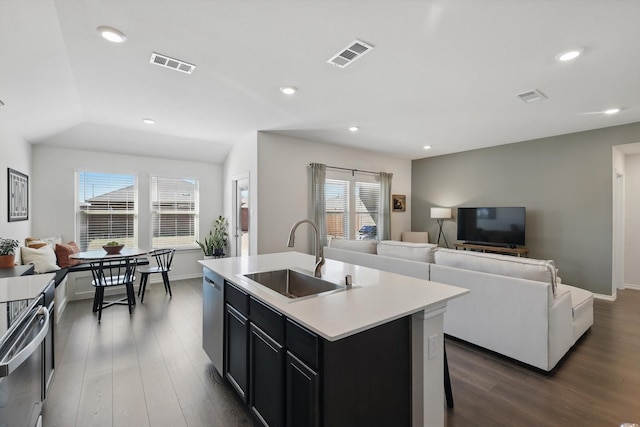 kitchen featuring open floor plan, visible vents, and a sink