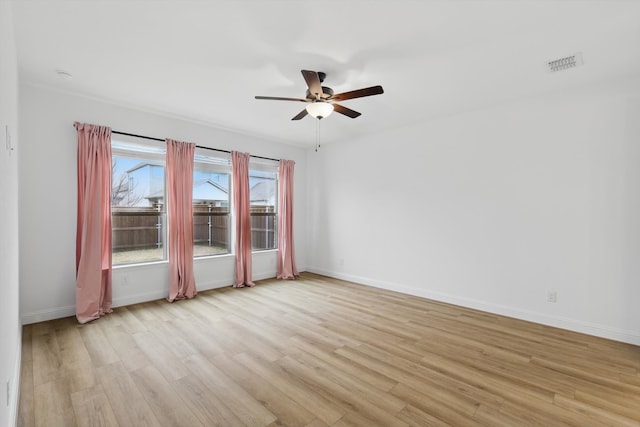 unfurnished room featuring visible vents, ceiling fan, light wood-style flooring, and baseboards