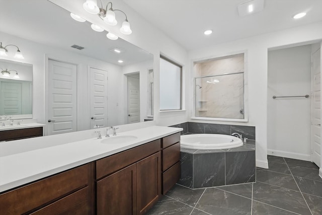 bathroom featuring a walk in shower, a garden tub, two vanities, a sink, and visible vents