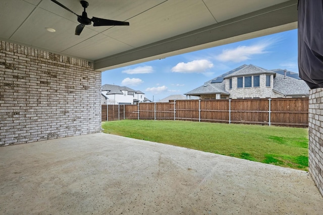 view of yard featuring a patio area, ceiling fan, and a fenced backyard