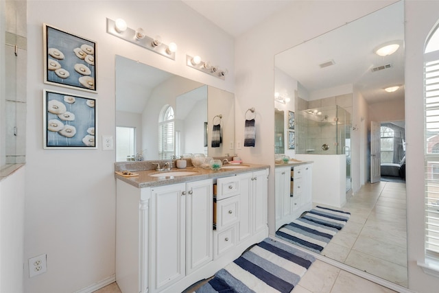 bathroom featuring a healthy amount of sunlight, a shower stall, double vanity, and visible vents