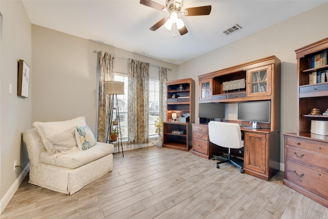 office space featuring visible vents, ceiling fan, light wood-style flooring, and baseboards