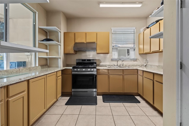 kitchen featuring open shelves, gas stove, light tile patterned flooring, a sink, and under cabinet range hood