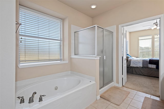 ensuite bathroom featuring ceiling fan, a shower stall, tile patterned floors, a whirlpool tub, and ensuite bath