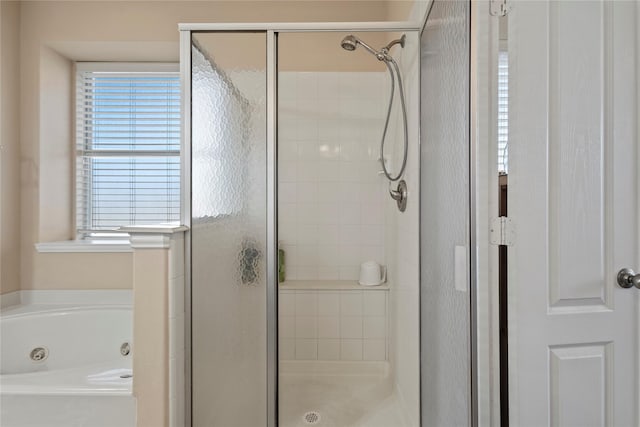 full bathroom featuring a stall shower and a jetted tub