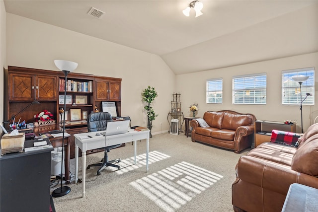 carpeted office space with lofted ceiling, visible vents, and baseboards