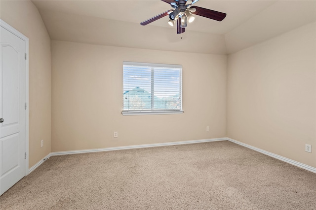 carpeted spare room with ceiling fan and baseboards