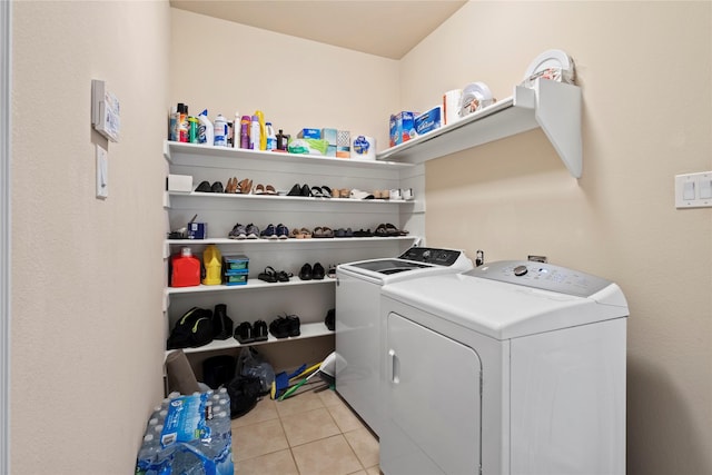 laundry room featuring light tile patterned floors, laundry area, and washer and dryer