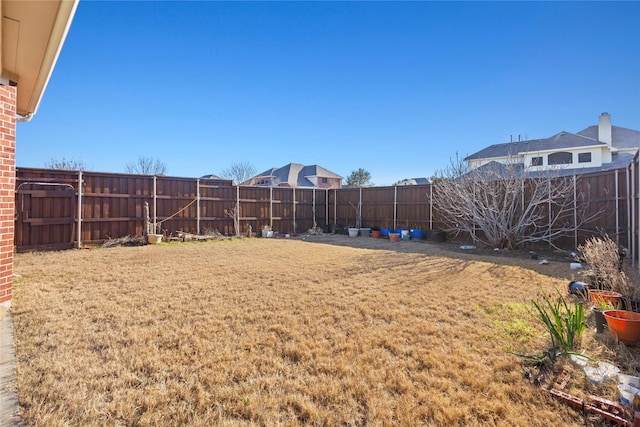 view of yard with a fenced backyard