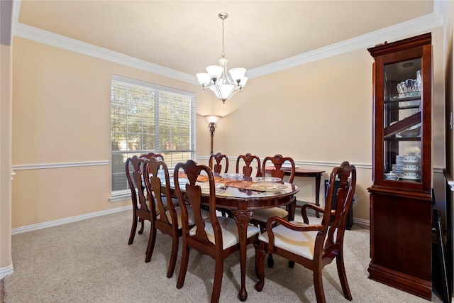 carpeted dining space with ornamental molding, baseboards, and an inviting chandelier