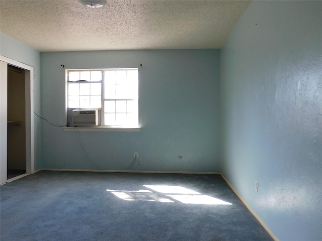 carpeted spare room with baseboards and a textured ceiling