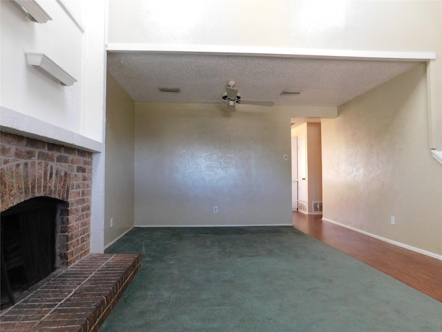 unfurnished living room featuring visible vents, baseboards, ceiling fan, a textured ceiling, and a brick fireplace