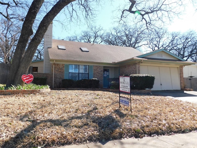 view of front facade with driveway, an attached garage, roof with shingles, and brick siding