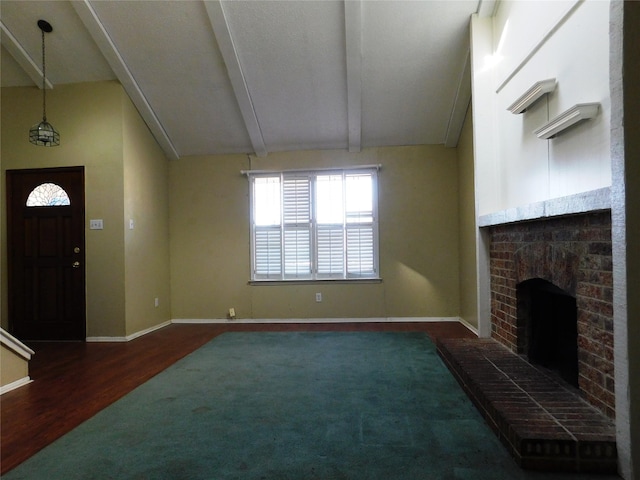 unfurnished living room with lofted ceiling with beams, a brick fireplace, baseboards, and wood finished floors