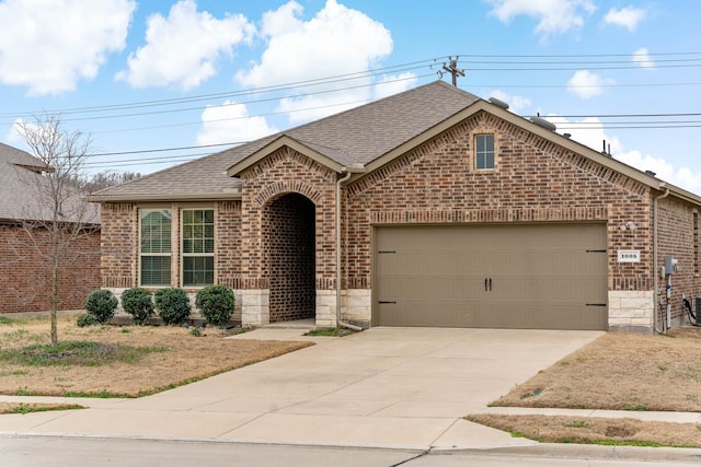 view of front facade with stone siding, brick siding, roof with shingles, and an attached garage