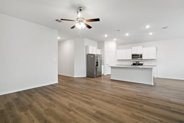 kitchen featuring visible vents, dark wood-style floors, appliances with stainless steel finishes, open floor plan, and backsplash