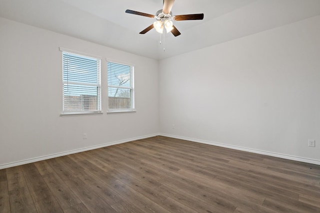 unfurnished room featuring a ceiling fan, baseboards, and dark wood-style flooring