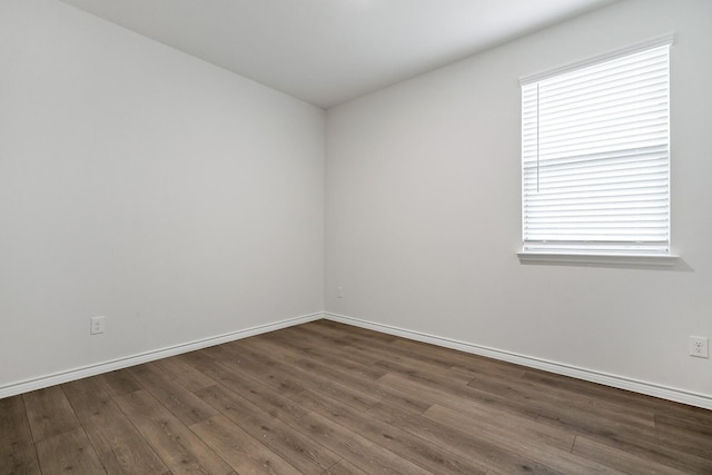 empty room with wood finished floors and baseboards