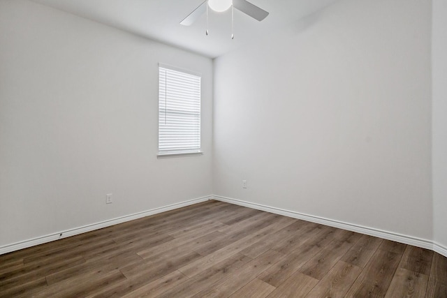 unfurnished room featuring a ceiling fan, baseboards, and wood finished floors