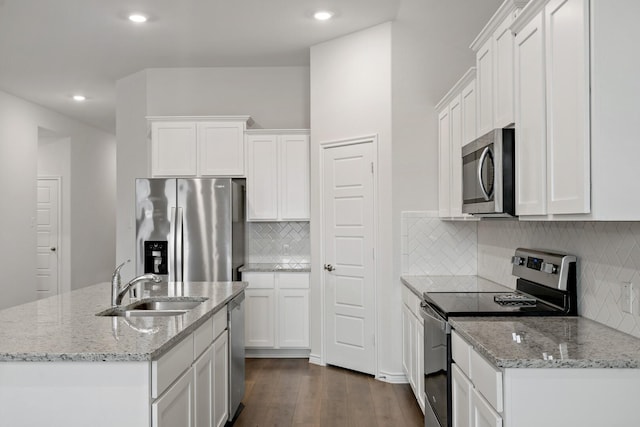 kitchen featuring stainless steel appliances, dark wood-style flooring, a sink, and white cabinets