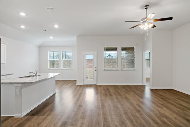 unfurnished living room featuring recessed lighting, wood finished floors, a ceiling fan, baseboards, and visible vents