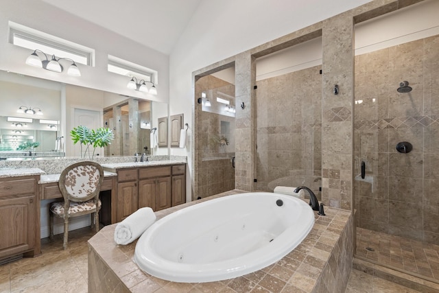 bathroom with lofted ceiling, a shower stall, and a tub with jets