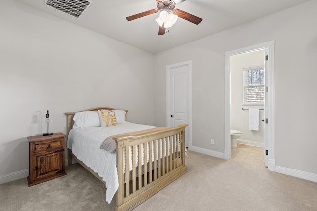 bedroom with baseboards, connected bathroom, visible vents, and carpet flooring