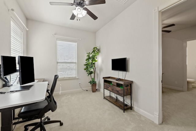 office with baseboards, a ceiling fan, and light colored carpet