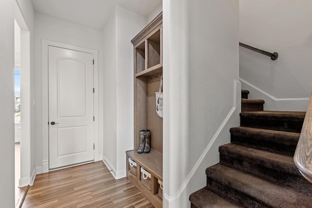 mudroom with light wood-type flooring and baseboards