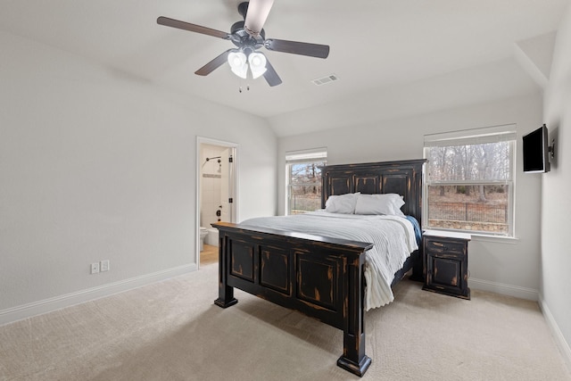 bedroom featuring baseboards, visible vents, connected bathroom, light colored carpet, and vaulted ceiling