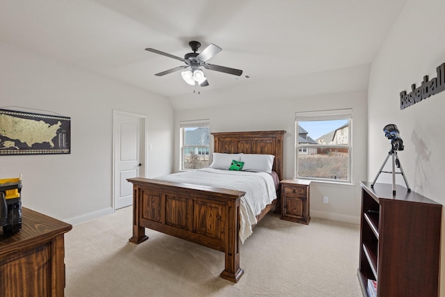 bedroom with lofted ceiling, light carpet, ceiling fan, and baseboards