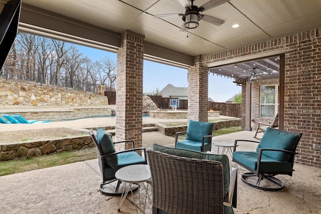 view of patio with a fenced backyard and a ceiling fan