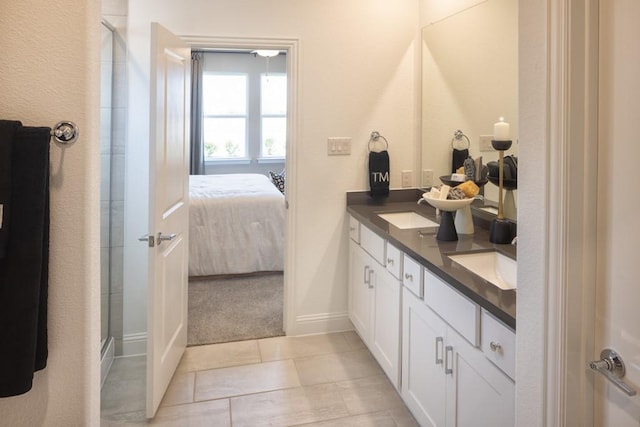 bathroom with a sink, a shower stall, double vanity, and connected bathroom