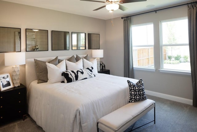 bedroom featuring ceiling fan, multiple windows, carpet, and baseboards