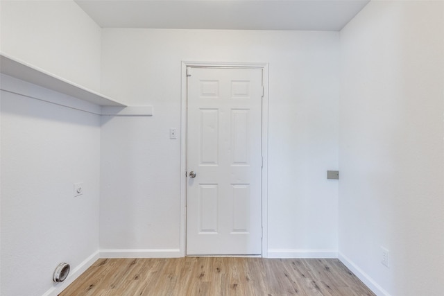 laundry room with laundry area, baseboards, hookup for an electric dryer, and light wood finished floors