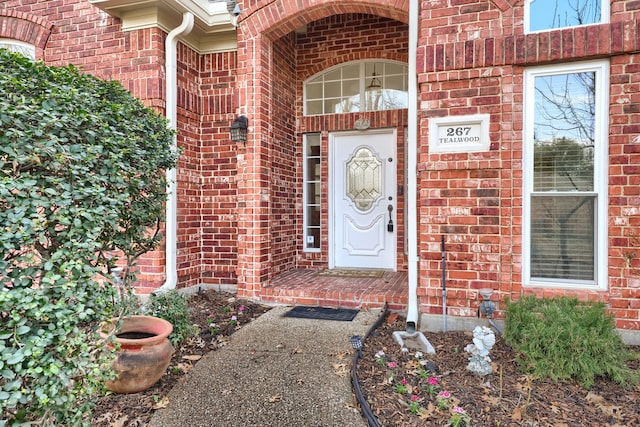 entrance to property with brick siding