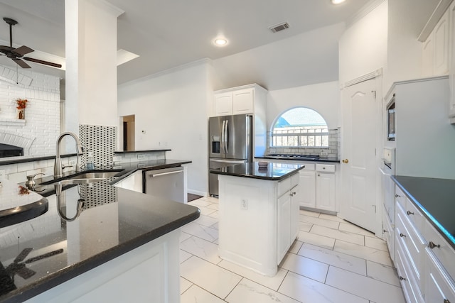 kitchen with a center island, marble finish floor, stainless steel appliances, visible vents, and decorative backsplash