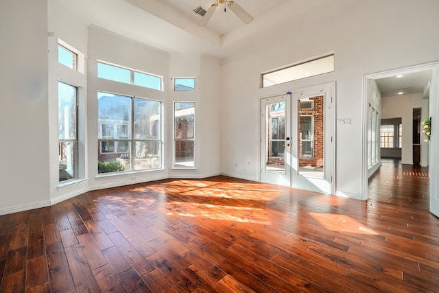 spare room with ceiling fan, french doors, wood finished floors, and visible vents