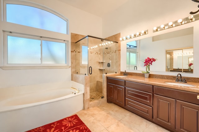 full bath featuring a garden tub, tile patterned flooring, a sink, and a stall shower