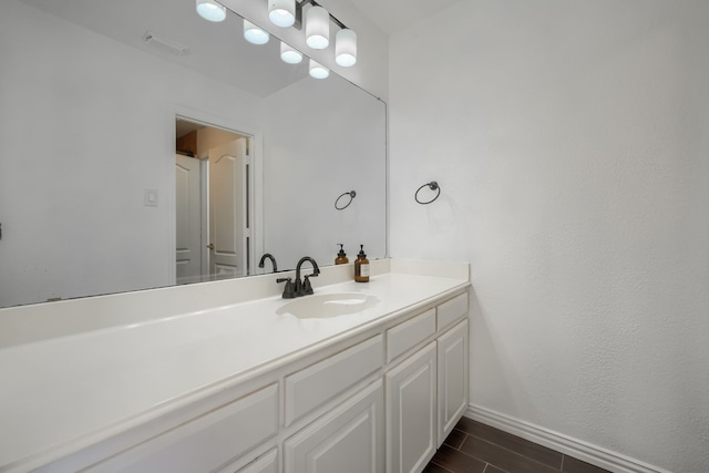 bathroom with wood tiled floor, visible vents, vanity, and baseboards