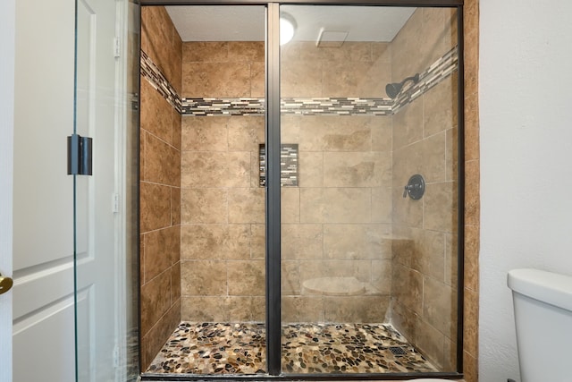 full bath with a shower stall and toilet