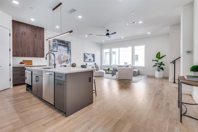 kitchen featuring a sink, visible vents, light countertops, and stainless steel dishwasher